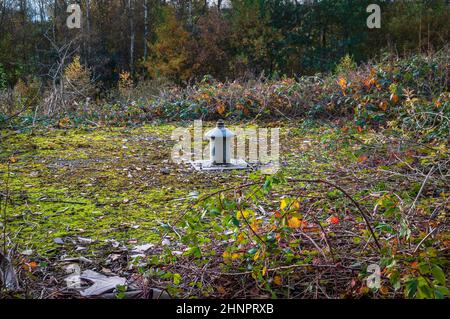 Methane ventilation pipe emerging from a concrete cap over a disused colliery shaft in northeast Derbyshire. Stock Photo