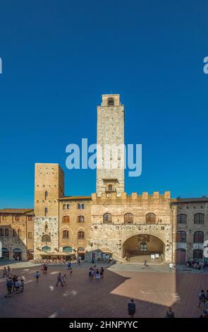 Old medieval square and towers in typical Tuscan town. Town also called  Medieval Manhattan for residential towers found therein in italy Stock Photo