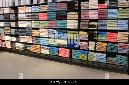 The Turkish carpets are on sale in shop. Products lie curtailed on shelves of shop Stock Photo