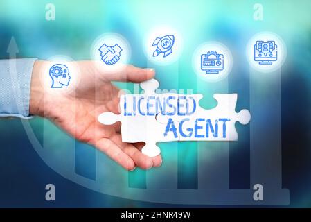 Writing displaying text Licensed Agent, Word for Authorized and Accredited seller of insurance policies Hand Holding Jigsaw Puzzle Piece Unlocking New Stock Photo