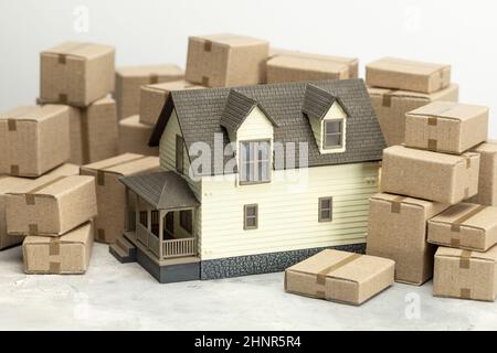 Moving day. Moving to a new home. House and cardboard boxes for moving. Stock Photo