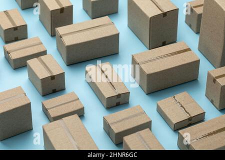 Lots of cardboard boxes pattern on a blue background. Stock Photo