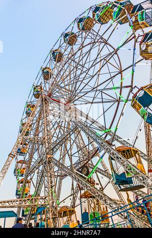 people enjoy the big wheel in the amusement park in Delhi in front of the red fort Stock Photo