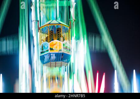 people enjoy the big wheel in the amusement park in Delhi Stock Photo