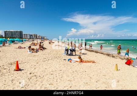 people enjoy the hot summer day at south beach in Miami Stock Photo