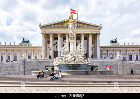 people relax at fountain of  The Austrian Parliament Building Stock Photo