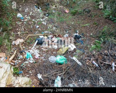different kinds of waste abandoned in nature, a symbol of pollution and incivility Stock Photo