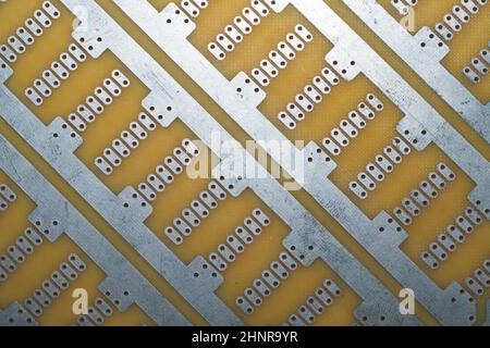 Printed circuit board without elements. textolite surface. template for soldering the circuit. perforated background Stock Photo