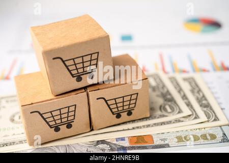 Shopping cart logo on box with US dollar banknotes on graph background. Banking Account, Investment Analytic research data economy, trading, Business Stock Photo