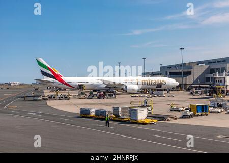 emirates aircraft at  passenger bridge at logan international airport in Boston Stock Photo