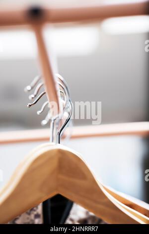 A hanger or clothes hook is a device in the shape of human shoulders designed to facilitate hanging especially jackets, sweaters, shirts, blouses or d Stock Photo