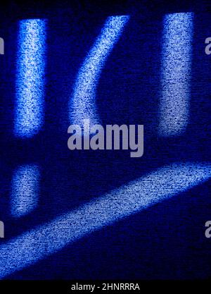 abstract design of blue lines and symbol shaped shadows on black on window blind from afternoon sun textured background or backdrop vertical format Stock Photo