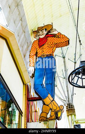 Famous cowboy neon sign at high above the Fremont Street. Stock Photo