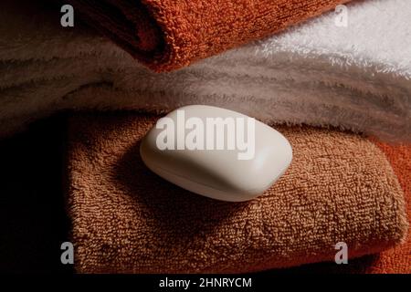 a bar of soap on fresh towels Stock Photo