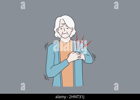 Unhappy sick old woman touch heart suffer from pain heart attack, need ambulance. Unhealthy mature grandmother struggle with chest ache burn. Elderly Stock Photo
