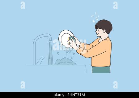 Small boy helper do housework wash dishes in kitchen singing having fun. Happy little kid child help with chores. Daily routine, house hygiene concept Stock Photo