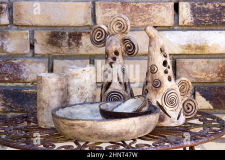 clay pots on a metal table -  handmade pottery Stock Photo