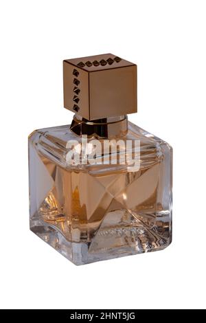 Perfume products isolated. Closeup of a gold brown glowing perfume glass bottle isolated on a white background. Empty label. Eau de Parfum. Clipping path. Macro photograph. Stock Photo