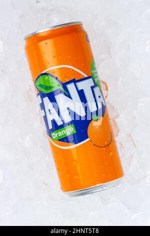 Fanta orange lemonade soft drink in a can on ice cubes portrait format Stock Photo