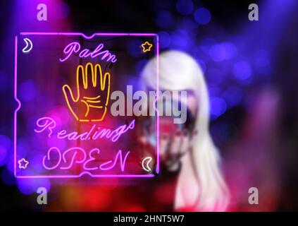 Psychic with Blond hair and Crystal Ball. Neon Lights in background Stock Photo