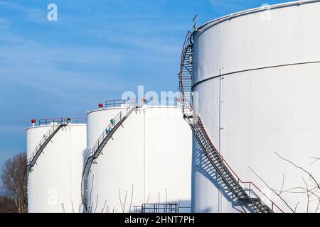 white tanks in tank farm with blue sky Stock Photo