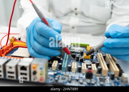 Technician repairing inside of hard disk by soldering iron. Integrated Circuit. the concept of data, hardware, and technology. Stock Photo