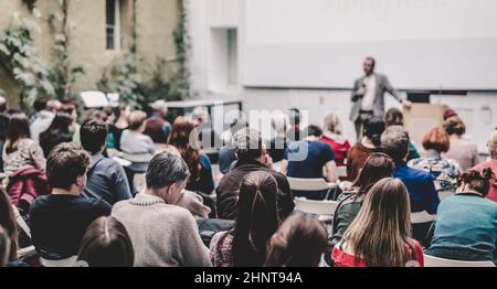 Man giving presentation in lecture hall at university. Stock Photo