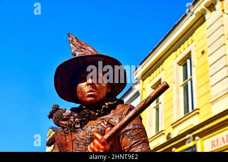 Living statue of witch. Live statue of sorceress. Living statue street performer. Stock Photo