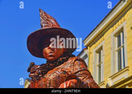 Living statue of witch. Live statue of sorceress. Living statue street performer. Stock Photo
