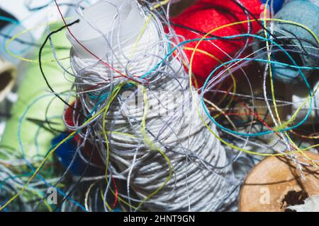 Tangled threads for sewing. different spools of thread Stock Photo