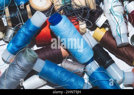 Tangled threads for sewing. different spools of thread Stock Photo