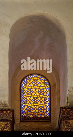 Mamluk era perforated stucco window with colorful stain glass with geometrical and floral patterns, Qalawun Complex Stock Photo