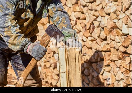 chopping firewood with a chopper close-up on a sunny day Stock Photo