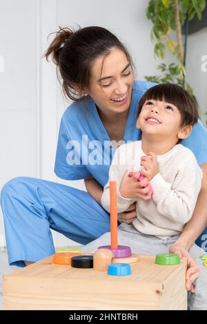 Disabled child is playing, learning and exercising in rehabilitation therapy hospital, Lifestyle of a child with disability. Happy disability kid concept. Stock Photo