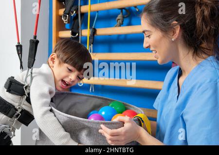 Disabled child is playing, learning and exercising in rehabilitation therapy hospital, Lifestyle of a child with disability. Happy disability kid concept. Stock Photo