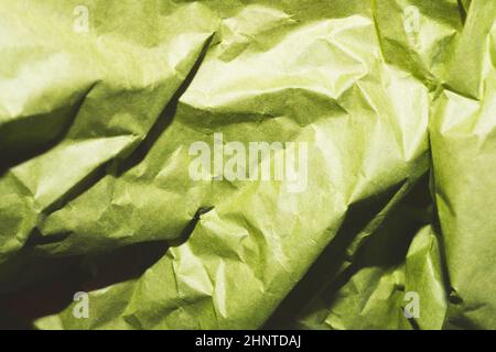 Crumpled green paper close up. creased kraft paper material Stock Photo