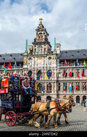 ANTWERP, BELGIUM - AUGUST 22, 2013: Tourists in a horse-drawn carriage in the Grote Markt (Great Market Square) of Antwerp, Belgium Stock Photo