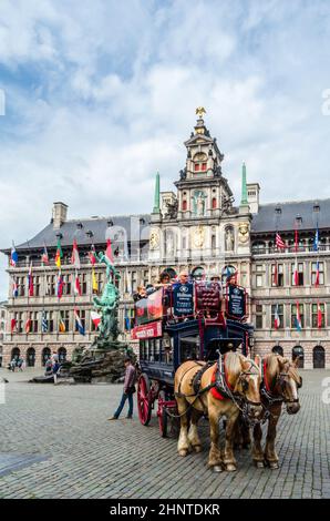 ANTWERP, BELGIUM - AUGUST 22, 2013: Tourists in a horse-drawn carriage in the Grote Markt (Great Market Square) of Antwerp, Belgium Stock Photo
