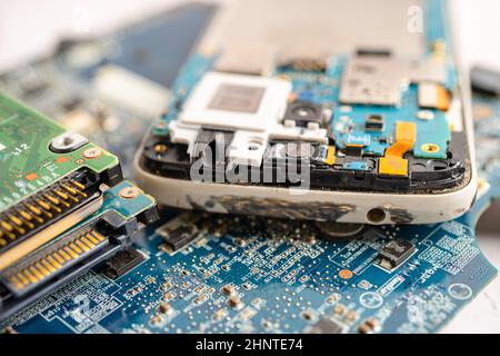 Technician repairing inside of mobile phone by soldering iron. Integrated Circuit. the concept of data, hardware, technology. Stock Photo