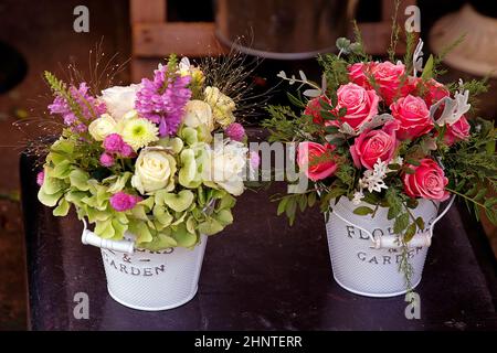 Rose flowers in metal buckets Stock Photo