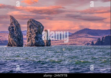 The scenery seascape at sunset: view of beautiful islands Three Brothers Rocks in Avacha Bay on Kamchatka Peninsula Stock Photo