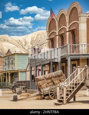 Vintage Far West town with saloon. Old wooden architecture in Wild West. Stock Photo