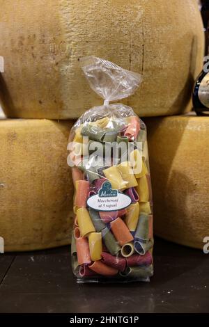 Whole wheel of Parmigiano Reggiano cheese and Italian pasta Stock Photo