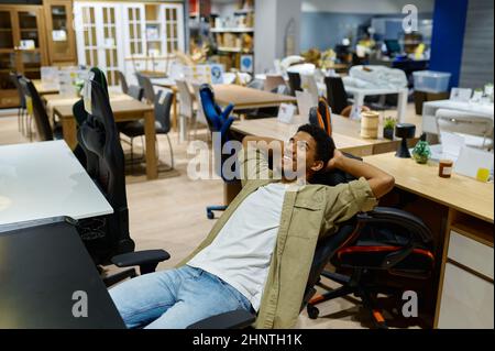 Man testing office armchair sitting on seat Stock Photo