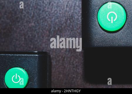 Green power buttons on the remote control close up Stock Photo
