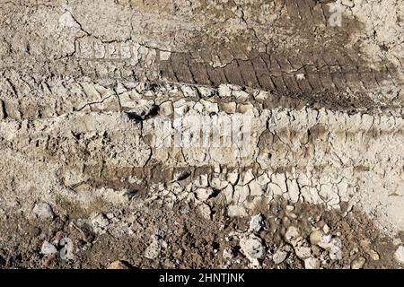 Close up on tire tracks on a muddy road Stock Photo