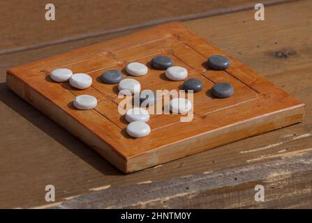 Reconstruction of roman board game Nine mens morris or mill game. Private recreational activity of ancient romans Stock Photo