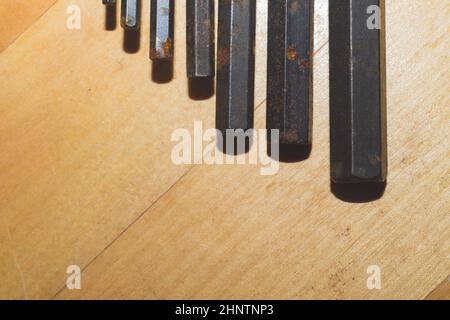 Allen wrenches set. old hexagonal wrenches on a wooden background Stock Photo