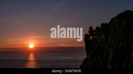 The famous Uluwatu Temple silhouetted at sunset, Bali, Indonesia. Stock Photo