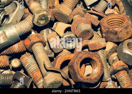 Rusty bolts and nuts of different sizes. scrap metal. industrial background Stock Photo